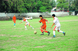   A match in progress at the District Football League in Dehradun on Friday. 