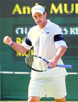 Andy Roddick celebrates after winning a point against Andy Murray. 