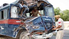 Cops carrying out inspection of a police bus, damaged after a head-on collision with a truck, near Kotshamir in Bathinda on Saturday.