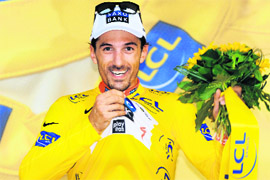 Danish cycling team Team Saxo Bank (SAX)'s rider Fabien Cancellara of Switzerland jubilates on the podium after winning the 15-km individual time-trial and first stage of the 2009 Tour de France around Monaco on Saturday.