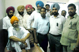 Financial Commissioner SS Brar and other senior officials of the excise and taxation department meet ETO Harminder Singh Sidhu at the Civil Hospital in Abohar on Monday. He had been assaulted by some traders last week.