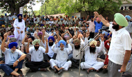 Employees of the GNDTP raising slogans against the management during a gate rally in Bathinda on Monday.