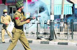 Cops fire tear gas shells to chase away protesters at Maisuma Chowk in Srinagar