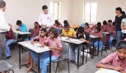 Students learn painting at a class organised by GE Capital in Gurgaon. 