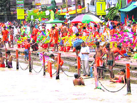Kanwariyas bathe at Har-Ki-Pauri in Haridwar on the first day of Kanwar Mela on Tuesday. 