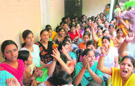 Students protest in front of Government College for Women, Gandhi Nagar, in Jammu on Tuesday.