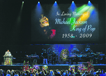 Musician Smokey Robinaon (L) speaks during the memorial service for Michael Jackson at the Staples Center in Los Angeles on Tuesday.