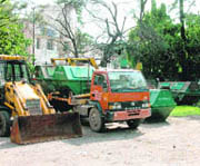 Garbage collection trucks at the Dehradun MC compound.