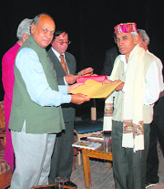 Chief Minister Prem Kumar Dhumal giving awards to prominent Hindi writers at the Gaiety Theatre in Shimla on Wednesday.  