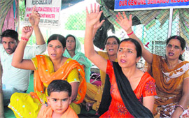 Members of the All J&K Home Guards Welfare Association protest in support of their pending demands at the Mubarak Mandi complex in Jammu on Wednesday. 