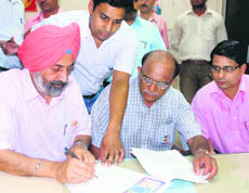 VC Jai Rup Singh signs a lease deed with a representative of Bacospin in Bathinda on Wednesday. On the extreme right is DC Rahul Tewari.