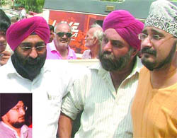Relatives of Jagmohan (inset), a businessman, who was found murdered at his residence in Rajouri Garden in Northwest Delhi on Thursday.