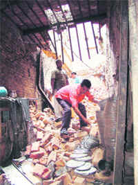 A man rummages through the debris of a building that collapsed in Amritsar on Thursday.