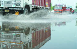 Vehicles caught on a waterlogged road near Rajghat in New Delhi on Friday.