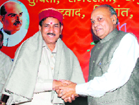 Chief Minister Prem Kumar Dhumal congratulating Khimi Ram on assuming the office of state BJP president at Shimla on Friday.