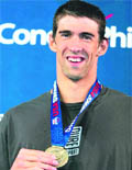 Michael Phelps poses with his medal after winning the mens 100 metre butterfly final and setting a new world record of 50.22 on Thursday.