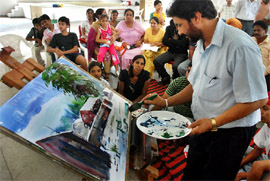 Artist Ashwani Kumar Verma demonstrates his painting skills during a workshop organised by the Shobha Singh Memorial Artist Society in Bathinda on Saturday.