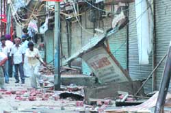 MCD workers demolish illegal constructions at Photo Market at Chandni Chowk of Old Delhi 