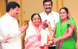 President Pratibha Patil felicitates sarpanch of Kothal Khurd village Roshni Devi at a function at Rashtrapati Bhawan in New Delhi 
