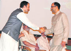 Nasir Aslam Wani shakes hand with Chief Minister Omar Abdullah after being inducted as a Cabinet minister in Srinagar on Saturday.