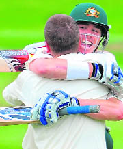 Brad Haddin (L) celebrates with fellow century maker Markus North after reaching 100 runs against England during the fourth day of the first Ashes cricket Test in Cardiff on Saturday.