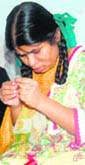 An inmate of Cheshire Home, Dehradun, learns stitching