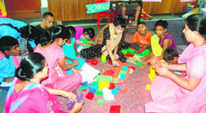 Teachers at a community rehabilitation class for slum kids.