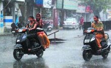 A sudden burst of rain brings smile on the faces of girls in Jalandhar on Monday.
