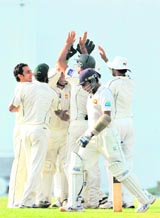 Saaed Ajmal (L) celebrates with teammates after the dismissal of Mahela Jayawardene during the second Test in Colombo on Monday.
