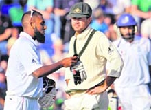 Australian captain Ricky Ponting looks on as Englands 12th man Bilal Shafayat brings out gloves on Sunday