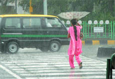 A girl caught in the rain in New Delhi on Tuesday.