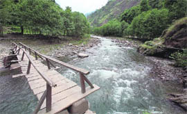 A wooden bridge on the Shoran Nullah which is the only means to connect a population of 30,000 with the rest of the country.