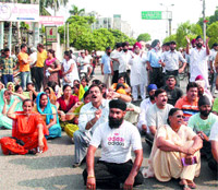 Parents of MGN students sit on a protest in Jalandhar on Monday.