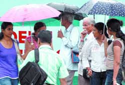 Residents enjoy the break from the hot spell when it rained extensively in New Delhi 