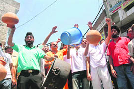BJP activists protest against the PHE Department and PHE Minister Taj-Mohi-ud-Din in Jammu on Wednesday.