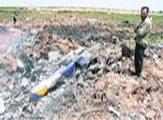 A man stands at the site where a Tupolev Tu-154 passenger plane crashed near Qazvin, about 150 km north of Teheran