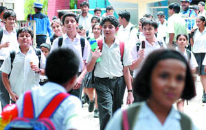 Students come out of Sardar Patel Vidyalaya at Lodhi Road in New Delhi after the school was closed on Thursday.