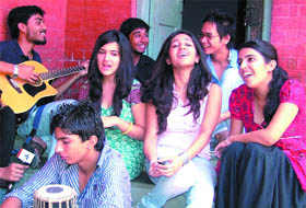 A senior plays guitar for freshers at Kirori Mal College.