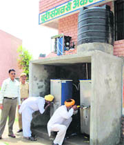 Inmates of the district jail, Sirsa, quench their thirst from a water purifier system installed in the jail.