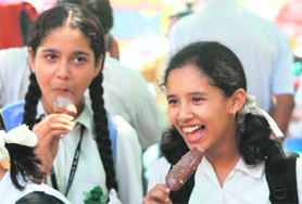 These girls enjoy their first day in school after completion of the summer vacation in Jammu on Thursday.