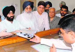 Jasjit Singh Bunny SAD and BJP candidate from Banur files his nomination papers in Dera Bassi on Thursday. Chief Minister Parkash Singh Badal can also be seen in the picture. 