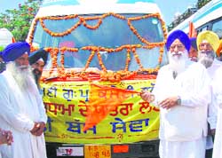 Avtar Singh, SGPC president, flags off a bus service for devotees in Amritsar 