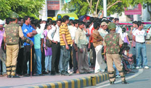 Policemen carry out a mock security drill at Palika Baazar and Connaught Place Inner Circle in New Delhi on Saturday.