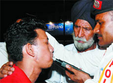 A Delhi traffic policeman conducts drunk driving test on a person in New Delhi on Friday.