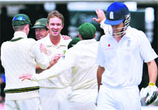Australian spinner Nathan Hauritz (3rd L) celebrates with teammates after dismissing Englands Alastair Cook on Saturday.
