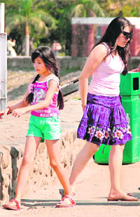 These girls make a fashion statement in their chic outfits as they walk crossways at the Sukhana Lake.