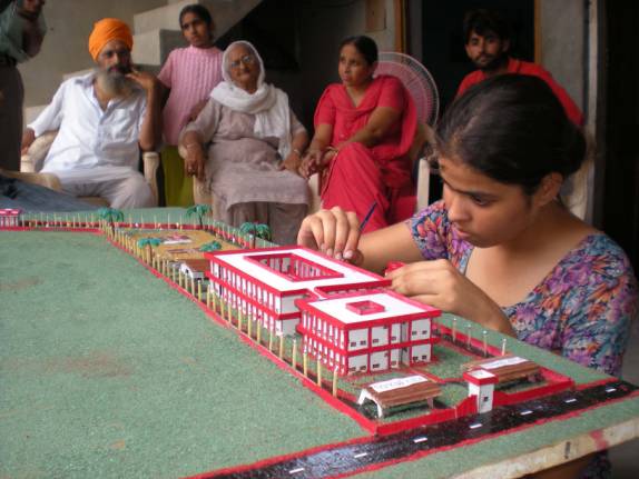 Kulwinder Kaur Dhiman busy giving final shape to a model at her home in Bathinda.