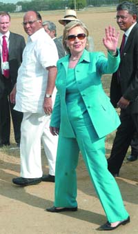 US Secretary of State Hillary Clinton waves to mediapersons as agriculture minister Sharad Pawar looks on during a visit to the Indian Agricultural Research Institute in New Delhi