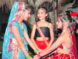 Girls converse backstage before a performance during a cultural function in Dehradun on Sunday. 