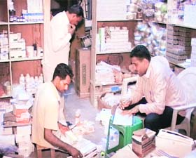 Members of the crime branch inspect drugs seized from a shop at Assandh in Karnal district